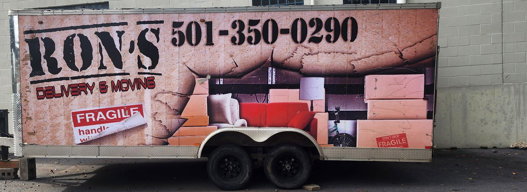 Ron's Delivery & Moving branded enclosed moving trailer