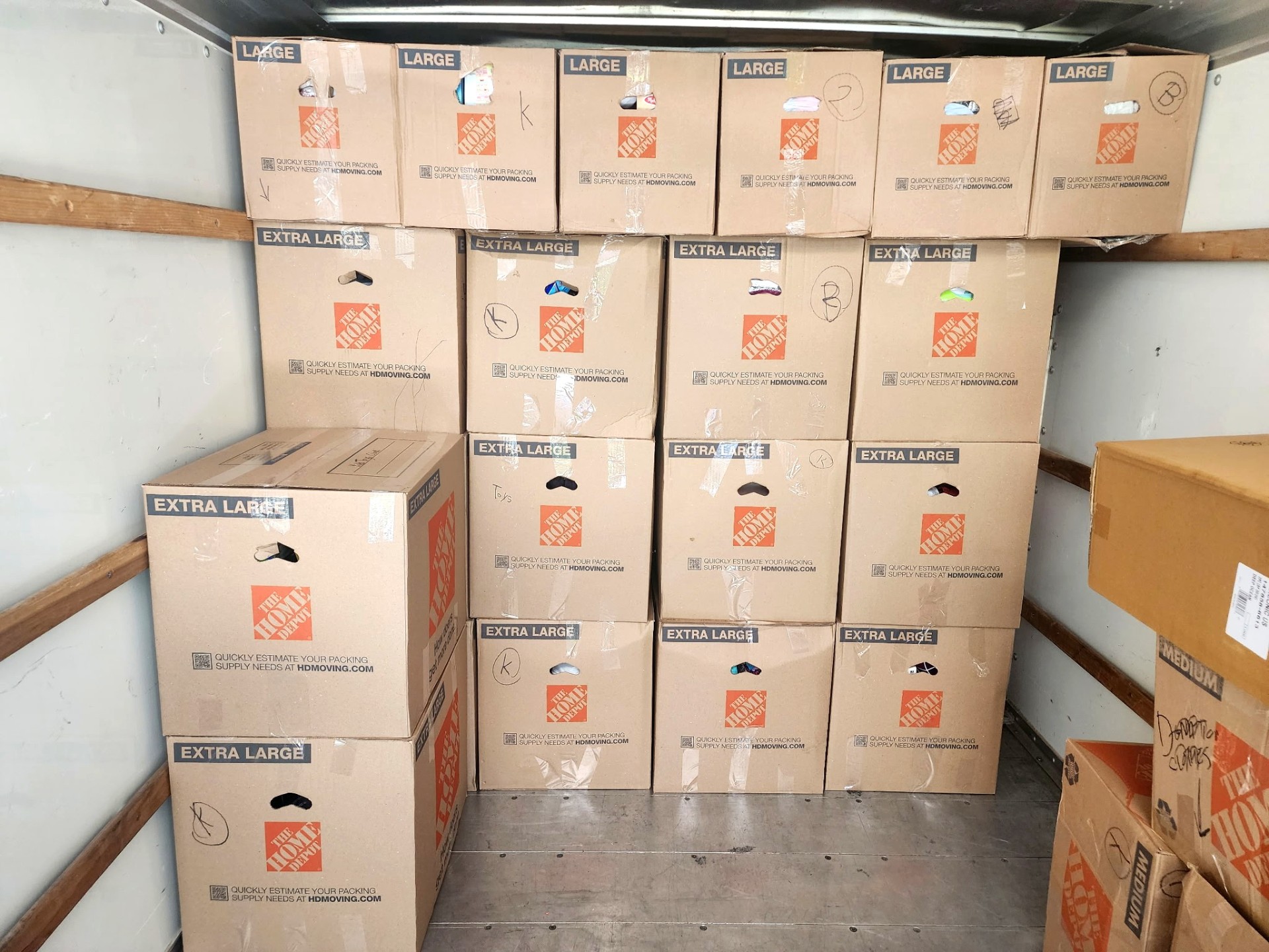 Ron's Delivery & Moving truck loaded with packed moving boxes